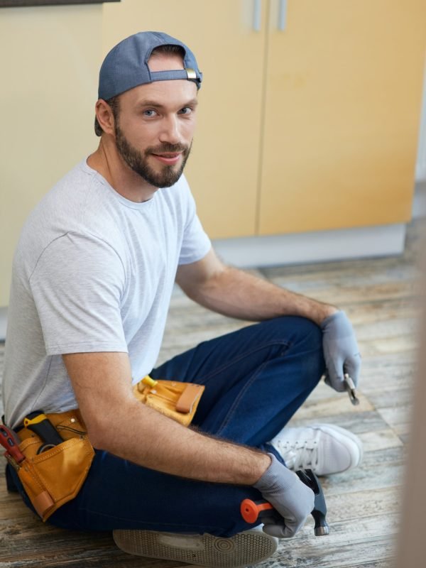 full-length-shot-of-young-repairman-looking-at-camera-holding-plumbing-tools-in-his-hands.jpg